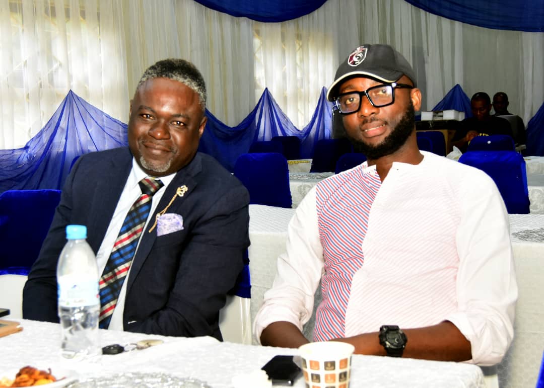 Two attendees smiling at a table