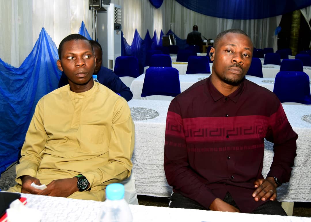 Two attendees listening from their seats