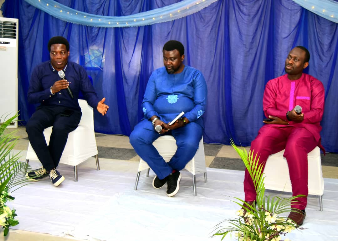 Three contributors seated on stage during the March gathering conversation