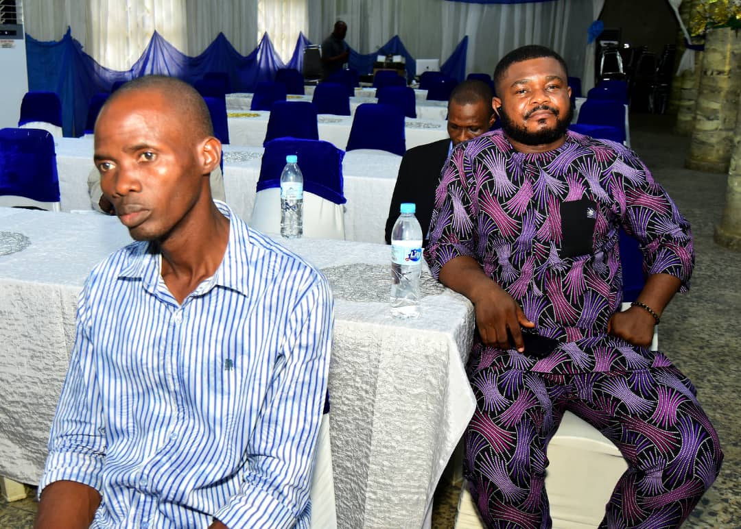Two attendees seated at tables in the venue