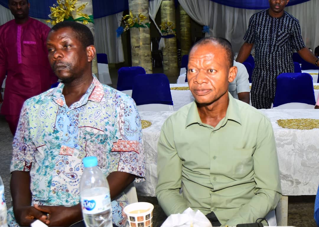 Two attendees seated side by side at a table