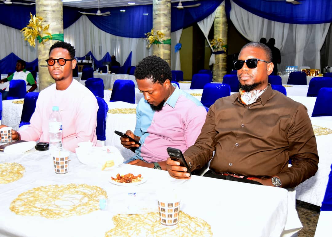 Three attendees seated together at a table