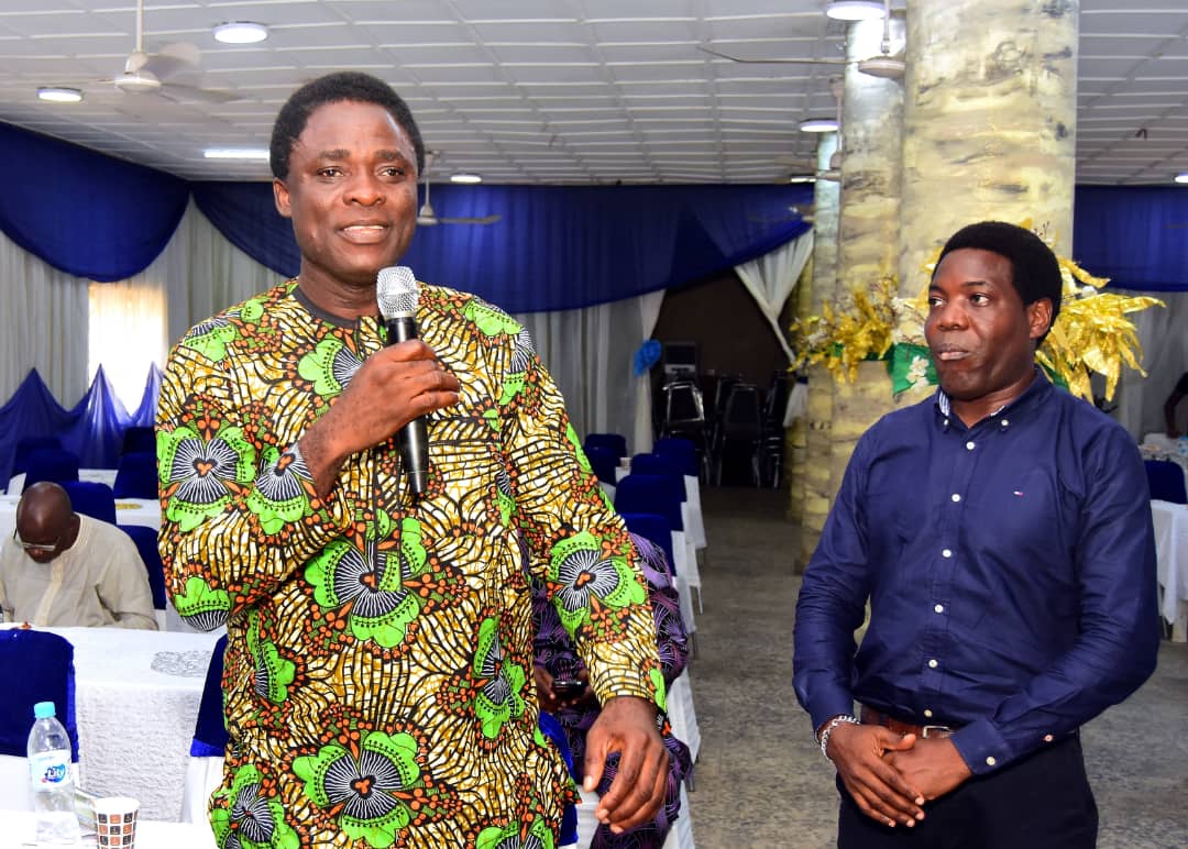 An attendee speaking into a microphone beside the host