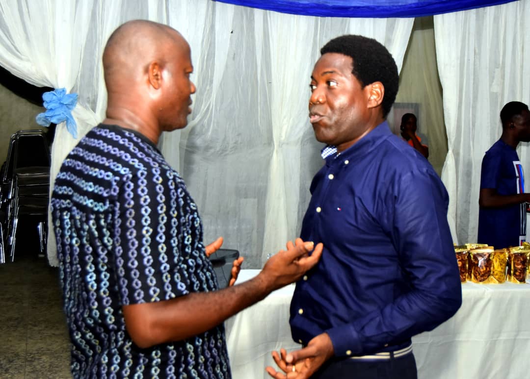 The host in conversation with an attendee near the refreshments